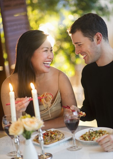 Couple enjoying fine meal in restaurant.