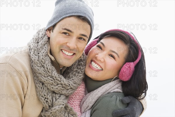 Couple wearing warm clothing smiling.