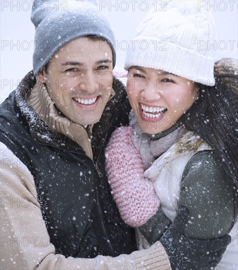 Couple wearing warm clothing smiling.