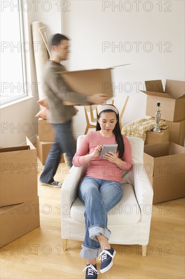 Man and woman unpacking things in new house.