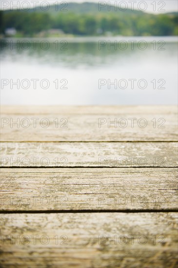 USA, New York, Putnam Valley, Roaring Brook Lake, Close up of wooden pier at lake. Photo: Jamie Grill