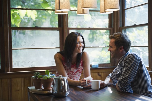 Roaring Brook Lake, Couple sitting at table. Photo : Jamie Grill