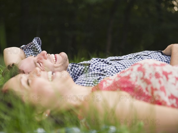 Roaring Brook Lake, Couple lying on grass. Photo: Jamie Grill