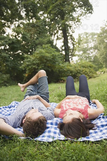 Roaring Brook Lake, Couple lying on grass. Photo : Jamie Grill