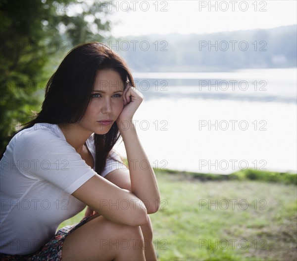 Roaring Brook Lake, Lonely woman sitting by lake. Photo : Jamie Grill