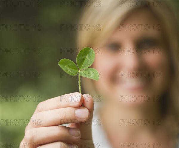 Roaring Brook Lake, Close up of woman's hand holding clover. Photo : Jamie Grill