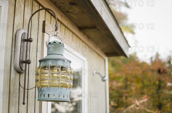 Close up of lantern on wooden hut. Photo: Jamie Grill