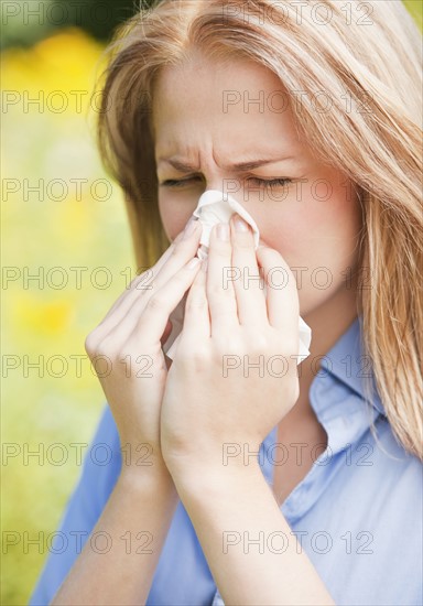 Close up of woman sneezing. Photo : Daniel Grill