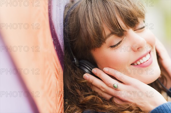 Portrait of smiling woman with headphones. Photo: Daniel Grill