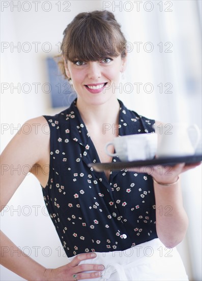 Portrait of smiling waitress. Photo : Daniel Grill