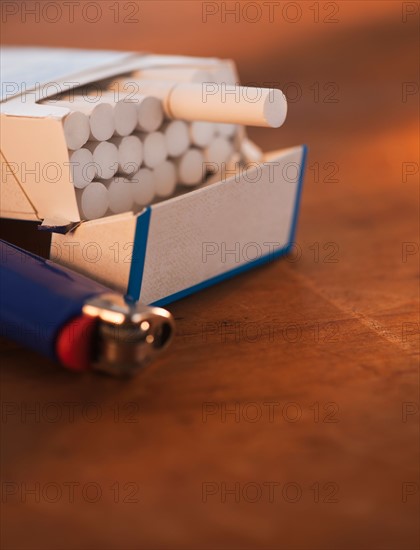 Close up of open cigarette pack and lighter. Photo : Daniel Grill