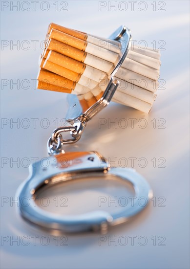 Close up of bunch of cigarettes locked in handcuffs. Photo: Daniel Grill