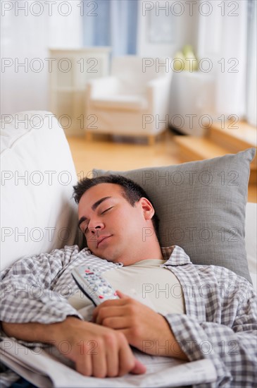 Man resting on sofa. Photo : Daniel Grill