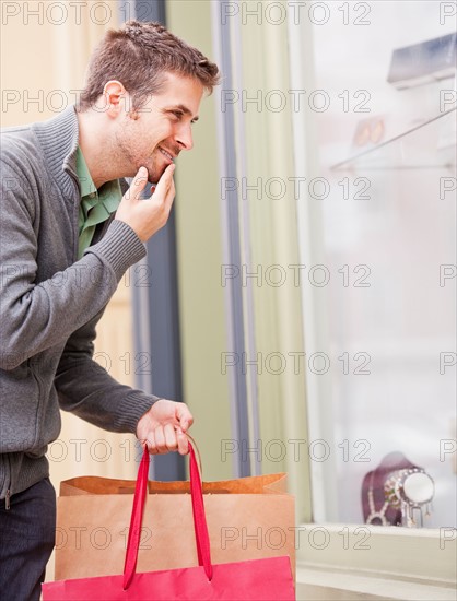 Man looking at window display. Photo: Daniel Grill