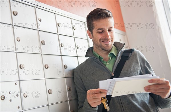 Man looking at correspondence. Photo: Daniel Grill