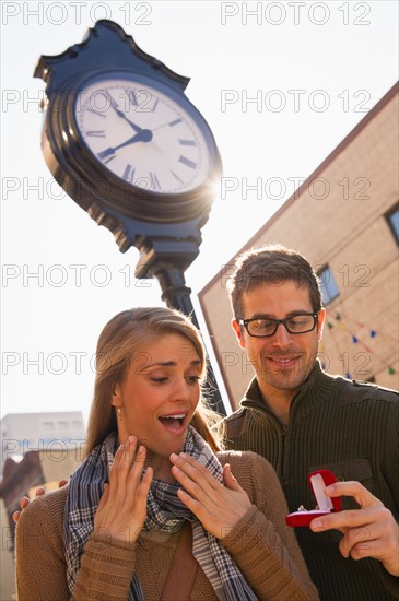 Man proposing to woman on street. Photo: Daniel Grill