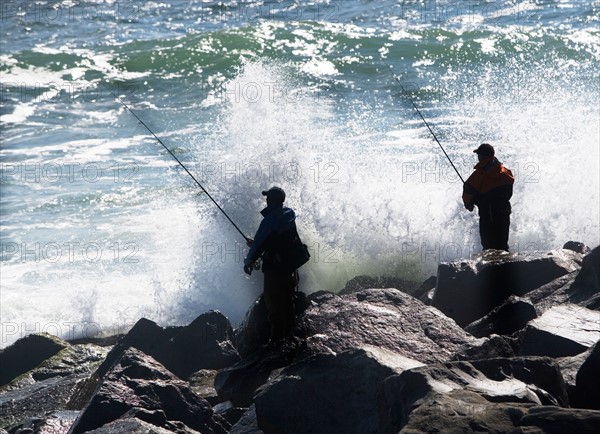 USA, New York, Long Island, Montaurk, Men fishing in sea. Photo: fotog