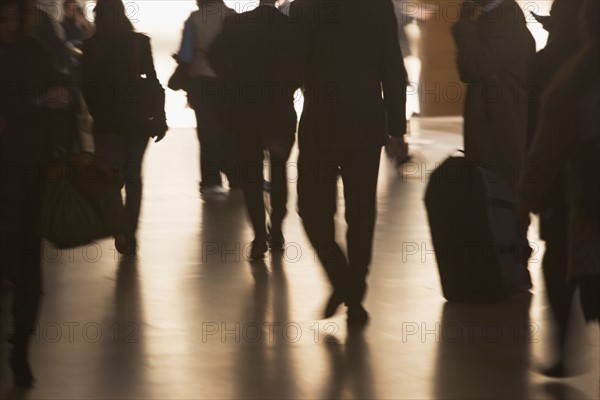 Urban scene with backlit pedestrians . Photo : fotog