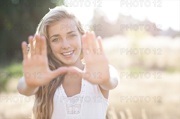 Teenage girl (16-17) displaying stop gesture. Photo: Take A Pix Media