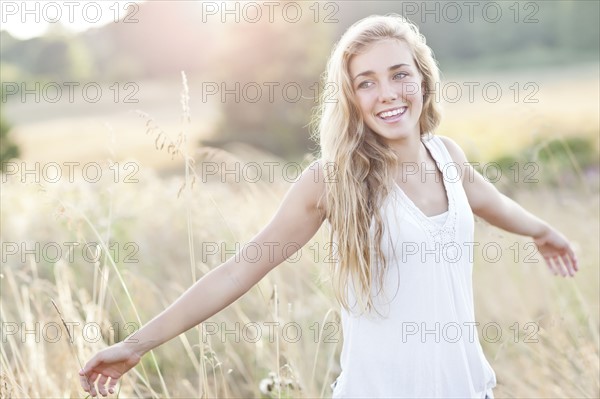 Happy teenage girl (16-17) enjoying bright sunshine. Photo : Take A Pix Media