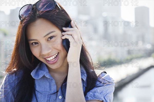 USA, Washington, Seattle, Woman talking on mobile phone outdoors. Photo: Take A Pix Media