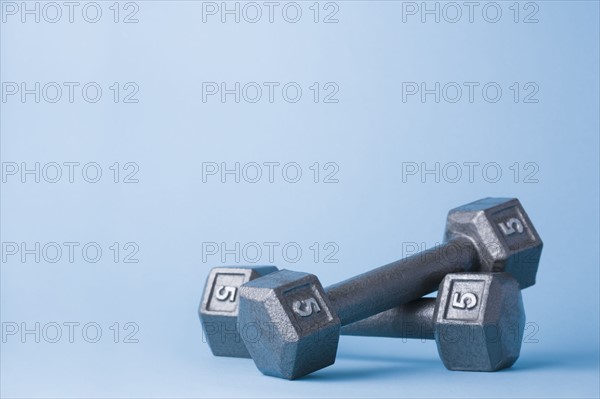 Pair of dumbbells on blue background. Photo : Kristin Lee