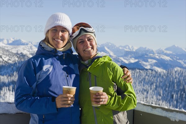 USA, Montana, Whitefish, Portrait of two women with mountains as backdrop. Photo : Noah Clayton