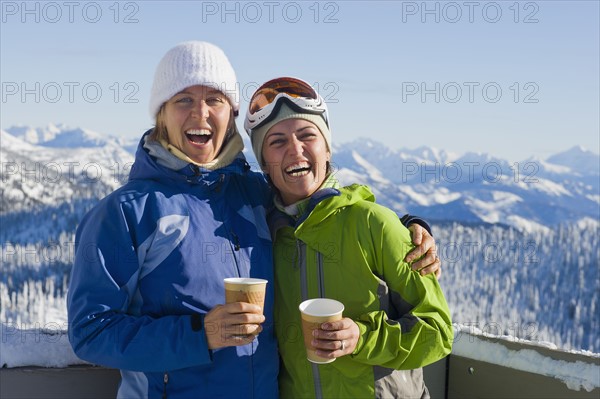 USA, Montana, Whitefish, Portrait of two women with mountains as backdrop. Photo : Noah Clayton