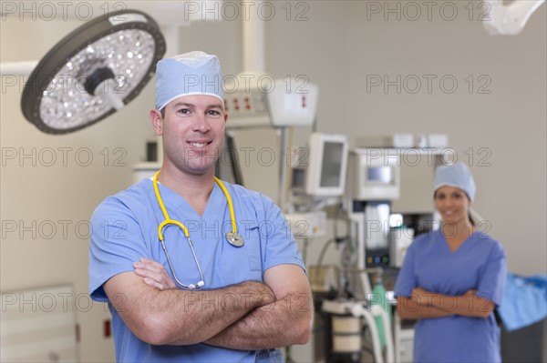 Portrait of male and female surgeons in operating room. Photo : db2stock