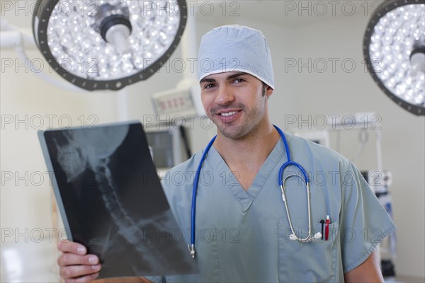 Portrait of doctor looking at x-ray. Photo : db2stock