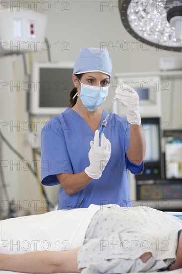 Surgeon preparing patient for surgery. Photo : db2stock