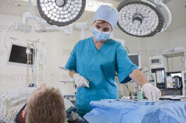 Surgeon preparing patient for surgery. Photo: db2stock