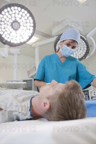 Surgeon preparing patient for surgery. Photo: db2stock