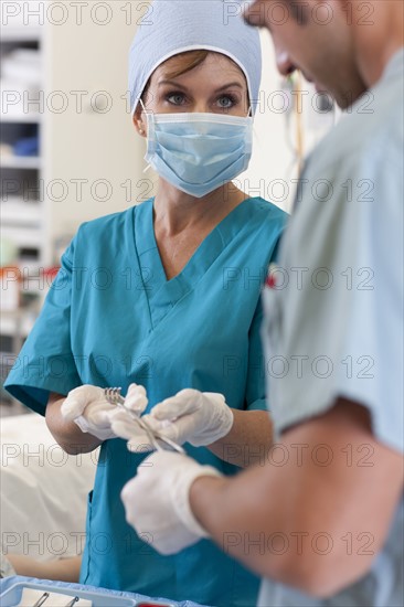 Surgeons holding tools. Photo : db2stock