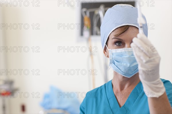 Surgeon preparing injection. Photo : db2stock