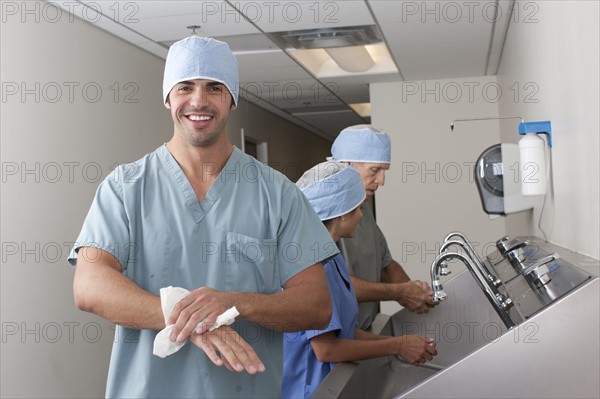 Surgeons washing hands in hospital. Photo: db2stock