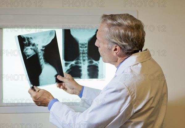 Doctor looking at x-ray. Photo : db2stock