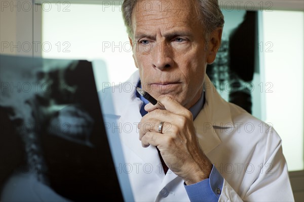 Doctor looking at x-ray. Photo : db2stock