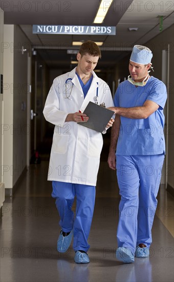 Doctor and surgeon walking in corridor. Photo : db2stock