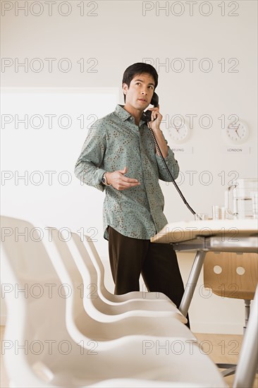 Businessman talking on phone. Photo : Rob Lewine