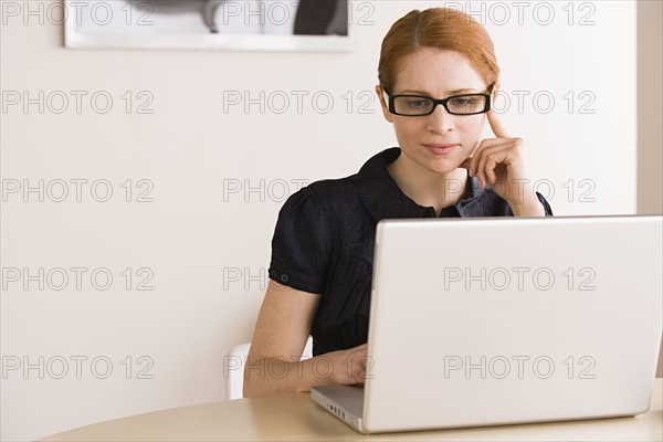 Businesswoman using laptop. Photo: Rob Lewine