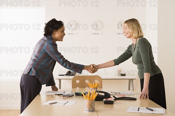 Business women shaking hands. Photo: Rob Lewine