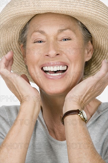 Studio portrait of senior woman wearing hat. Photo : Rob Lewine