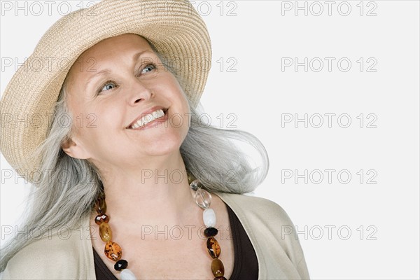 Studio portrait of mature woman wearing hat. Photo : Rob Lewine