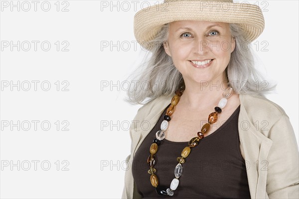 Studio portrait of mature woman wearing hat. Photo: Rob Lewine