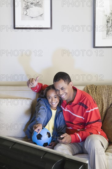 Father and Daughter (10-11) watching tv. Photo : Rob Lewine