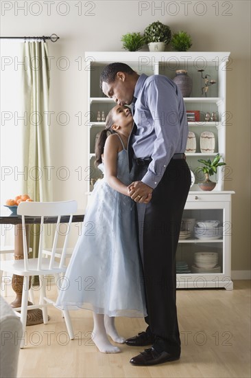 Father and Daughter (10-11) dancing in room. Photo: Rob Lewine