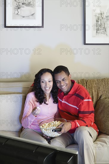 Couple watching tv. Photo: Rob Lewine