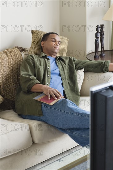 Man napping on sofa. Photo : Rob Lewine