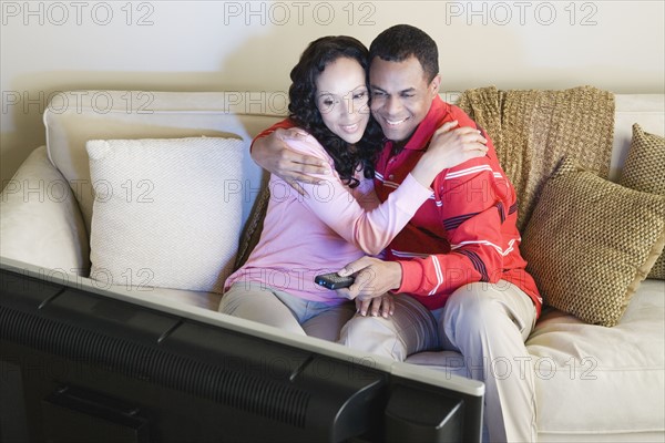 Couple watching tv. Photo : Rob Lewine